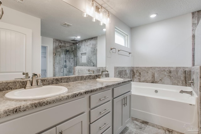 1825 Peace Ter, Cantonment, FL 32533 - full bathroom featuring a bath, double vanity, a shower stall, and a sink