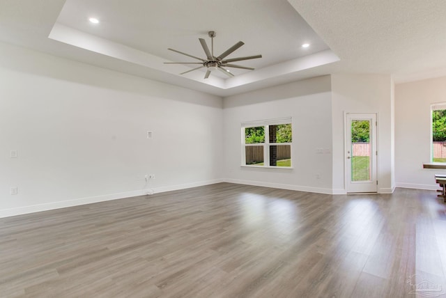 1825 Peace Ter, Cantonment, FL 32533 - unfurnished living room featuring a ceiling fan, wood finished floors, recessed lighting, and a raised ceiling