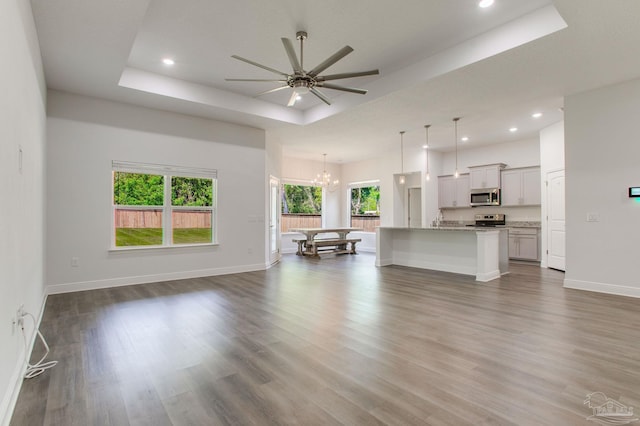 1825 Peace Ter, Cantonment, FL 32533 - living room featuring recessed lighting, wood finished floors, a tray ceiling, and ceiling fan with notable chandelier