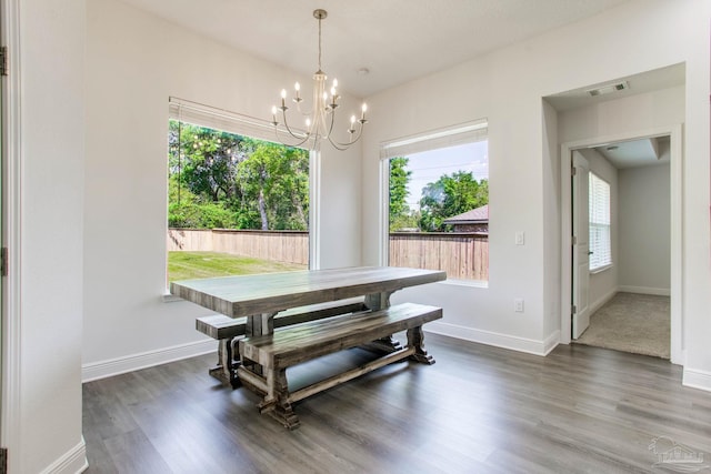 1825 Peace Ter, Cantonment, FL 32533 - dining space featuring an inviting chandelier, wood finished floors, visible vents, and a wealth of natural light
