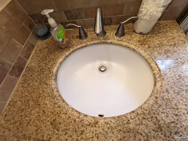 room details featuring sink and decorative backsplash