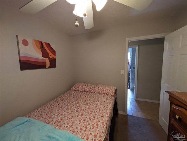 bedroom with dark tile patterned flooring and ceiling fan