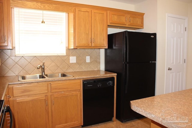 kitchen featuring light tile patterned floors, black appliances, sink, and decorative backsplash