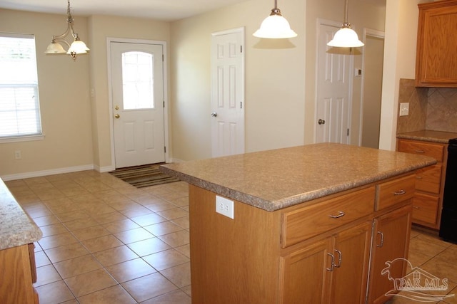 kitchen featuring decorative backsplash, light tile patterned floors, a kitchen island, and a wealth of natural light