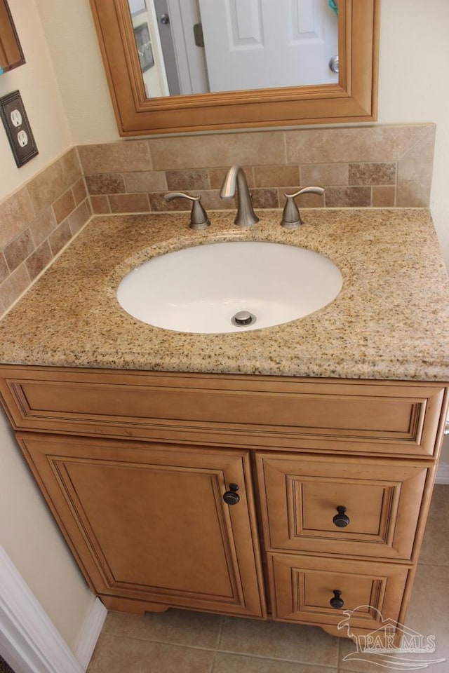 bathroom with vanity, decorative backsplash, and tile patterned flooring