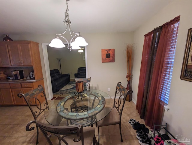 tiled dining area with a notable chandelier