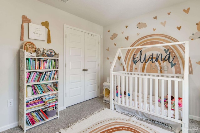 10869 Blacktail Loop, Pensacola, FL 32526 - carpeted bedroom featuring a closet, a nursery area, wallpapered walls, and baseboards