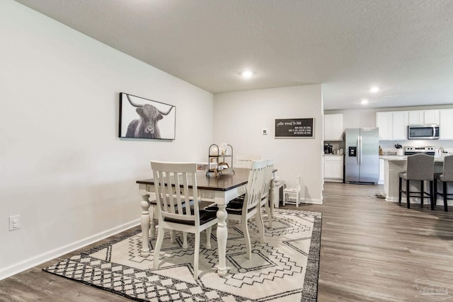10869 Blacktail Loop, Pensacola, FL 32526 - dining area with wood finished floors, recessed lighting, baseboards, and a textured ceiling