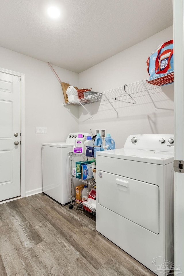 10869 Blacktail Loop, Pensacola, FL 32526 - clothes washing area with washing machine and dryer and light wood-type flooring