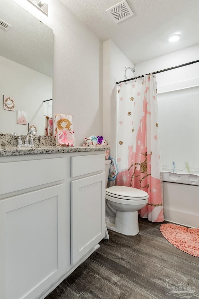 10869 Blacktail Loop, Pensacola, FL 32526 - bathroom featuring toilet, wood finished floors, vanity, and a shower with shower curtain