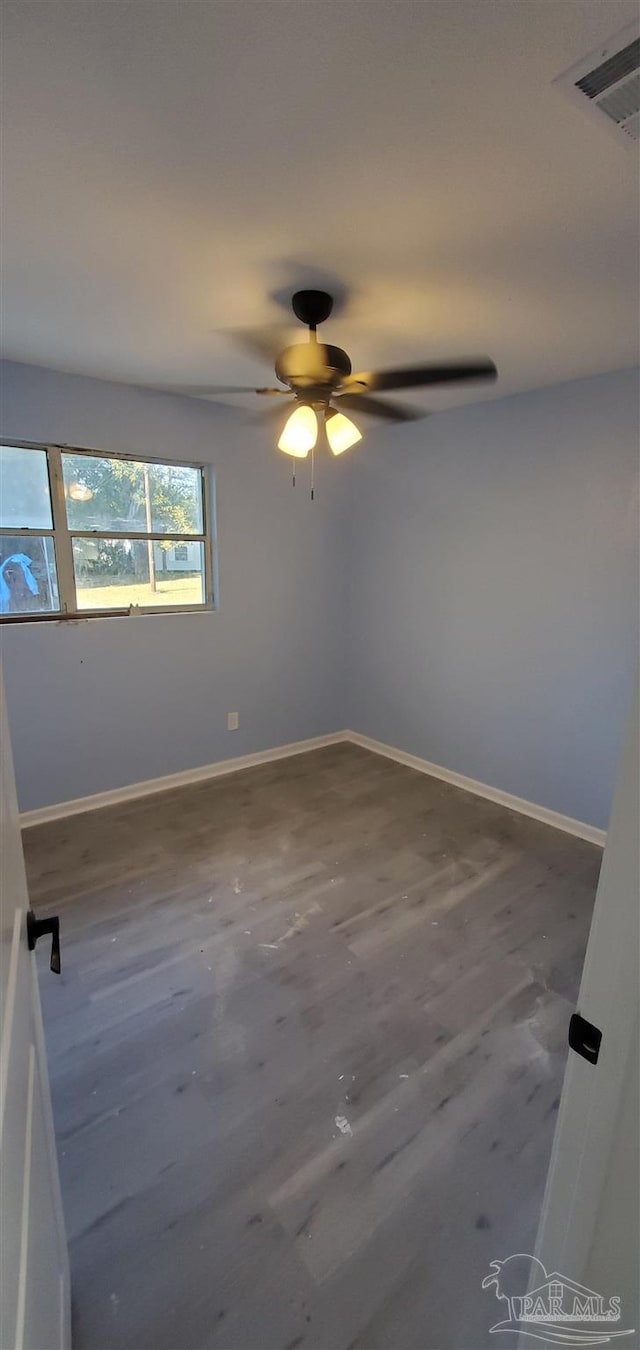 empty room with ceiling fan and wood-type flooring