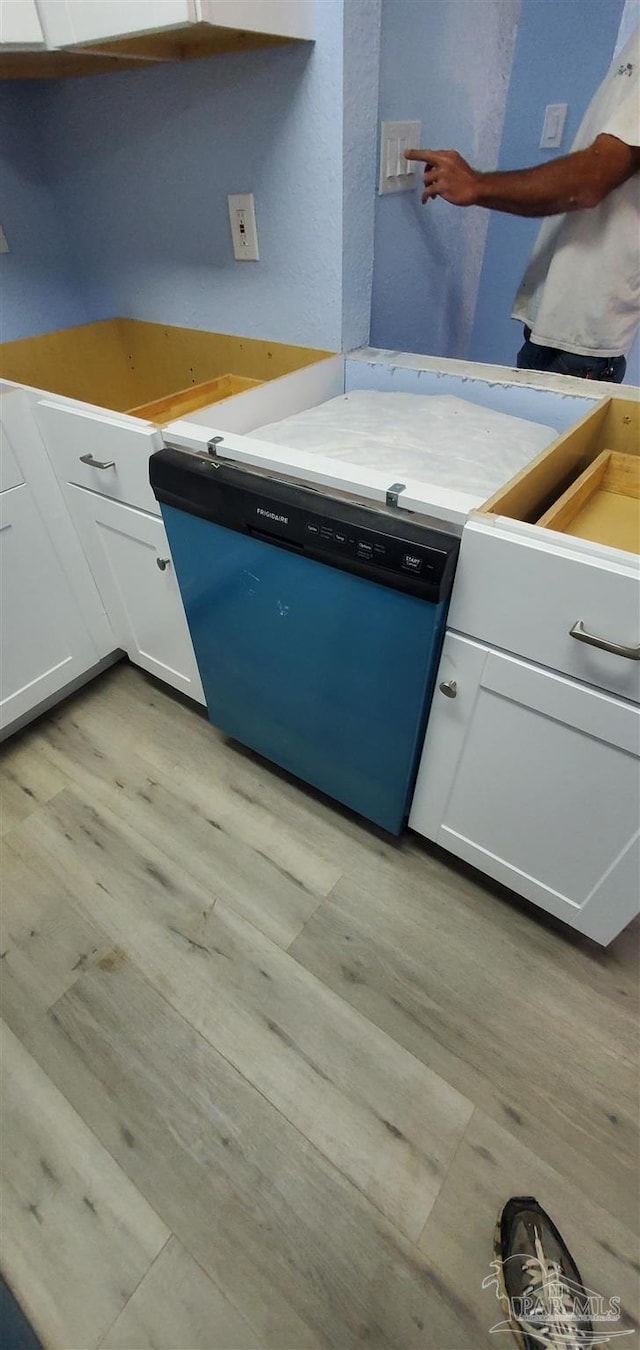 kitchen featuring white cabinets, light wood-type flooring, and dishwasher