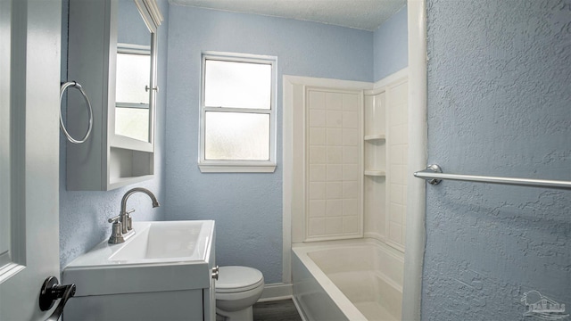 full bathroom with vanity, toilet, a textured ceiling, and bathtub / shower combination