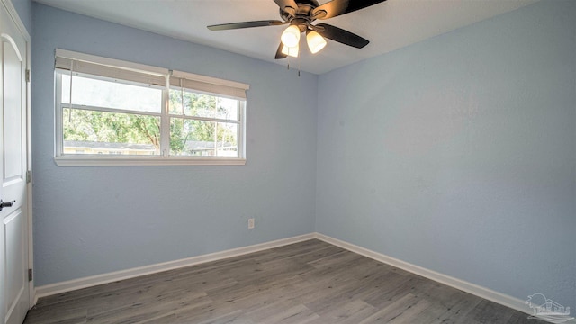 unfurnished room with hardwood / wood-style floors and ceiling fan