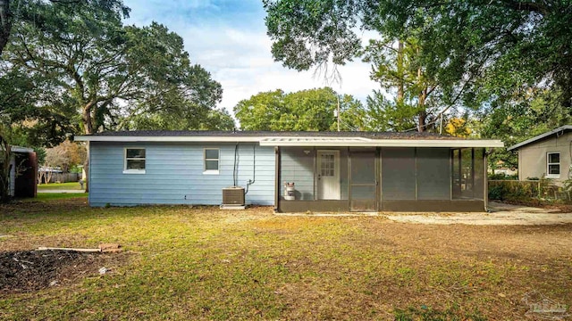 back of property featuring a yard and a sunroom