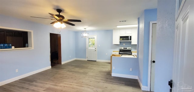 kitchen with white cabinetry, light hardwood / wood-style flooring, ceiling fan, and stainless steel appliances