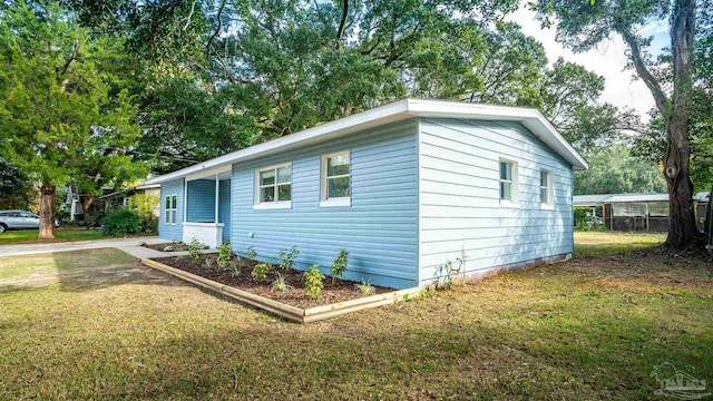 view of side of home featuring a lawn