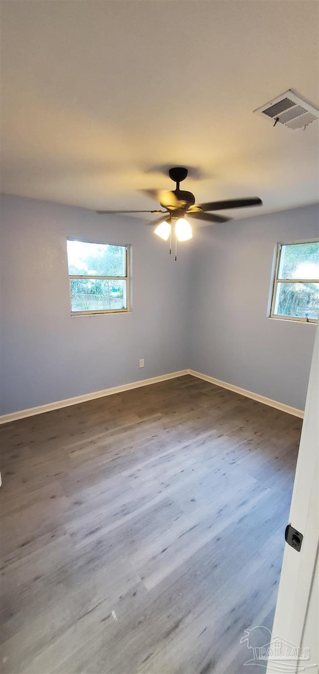 spare room with ceiling fan and dark wood-type flooring