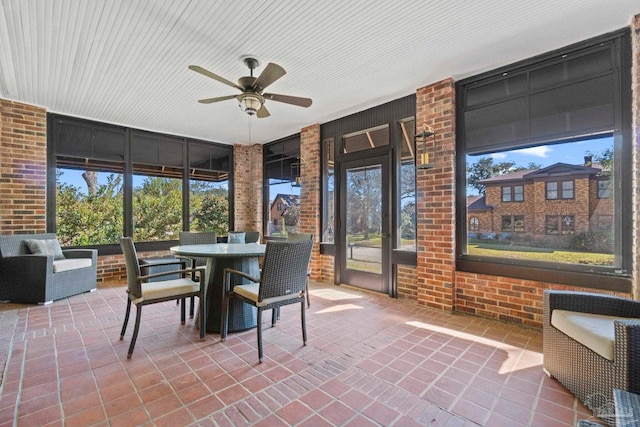 sunroom / solarium with a ceiling fan