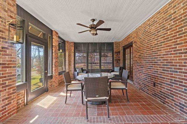 sunroom / solarium with a ceiling fan