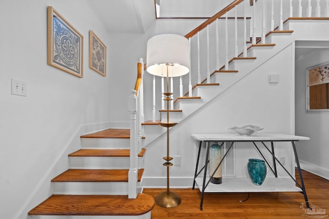 stairs featuring baseboards and wood finished floors