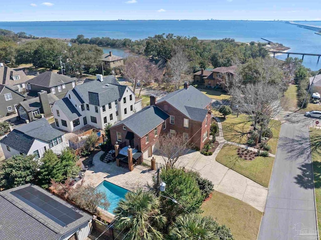 bird's eye view featuring a water view and a residential view