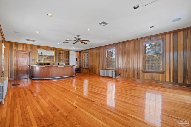 interior space featuring crown molding, a wealth of natural light, and radiator