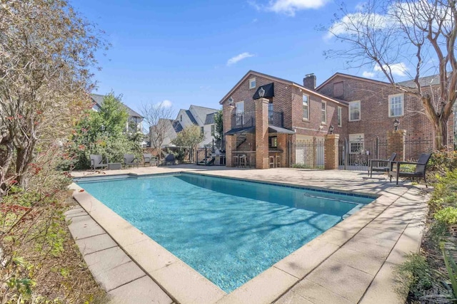 pool featuring a patio area and fence