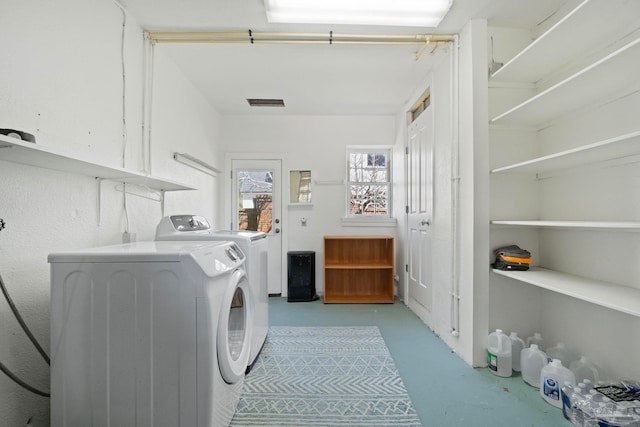 clothes washing area featuring laundry area, washing machine and clothes dryer, and visible vents