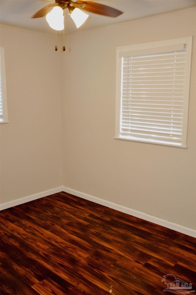 spare room with a ceiling fan, wood finished floors, and baseboards