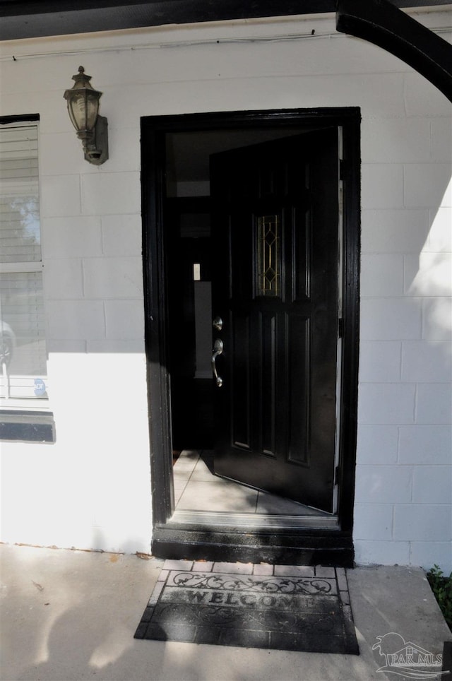 property entrance with concrete block siding