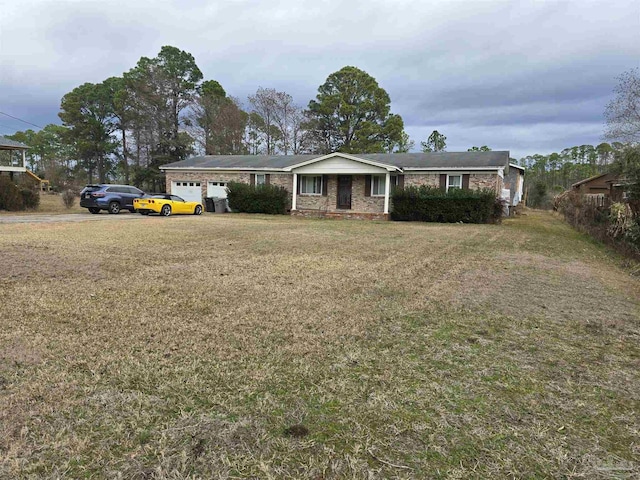 ranch-style home featuring a garage and a front yard