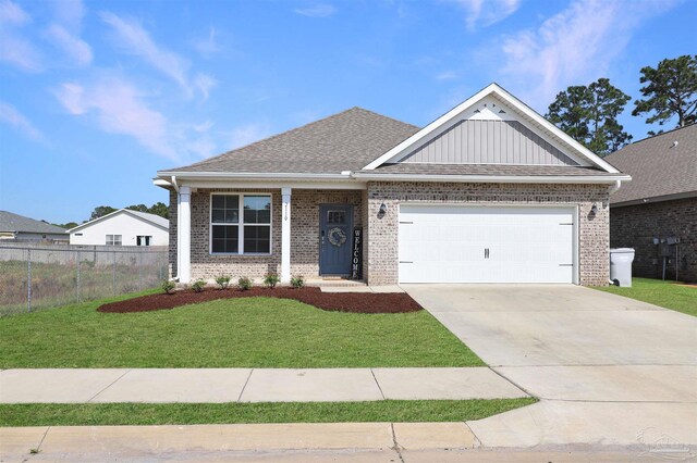 view of front of house with fence, a front lawn, brick siding, and a garage