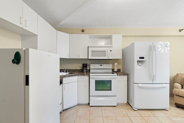 kitchen featuring light tile patterned flooring, white appliances, white cabinetry, and sink