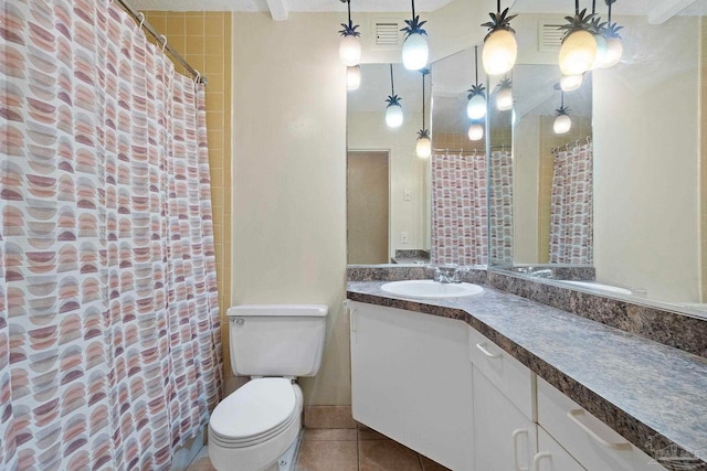 bathroom featuring vanity, tile patterned flooring, and toilet