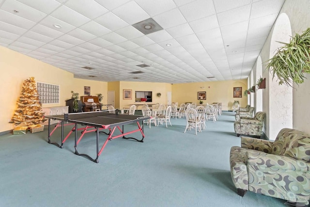 game room featuring a paneled ceiling and carpet flooring