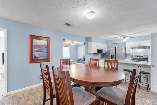 dining area featuring a textured ceiling