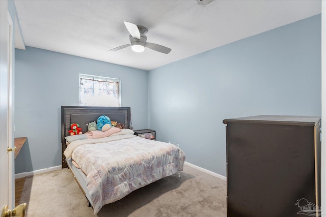 bedroom with ceiling fan and light carpet