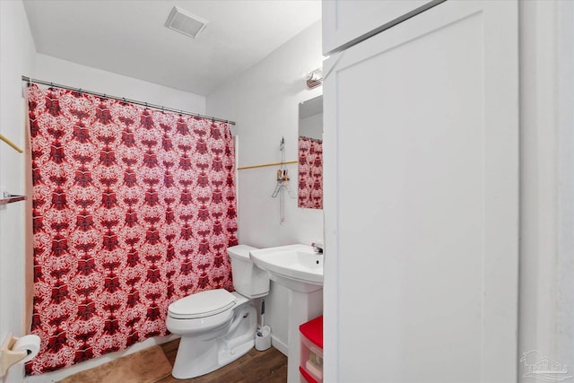 bathroom featuring toilet and wood-type flooring