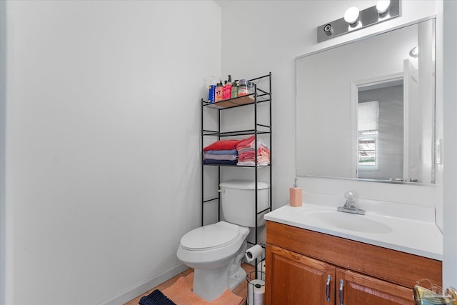 bathroom with toilet and vanity