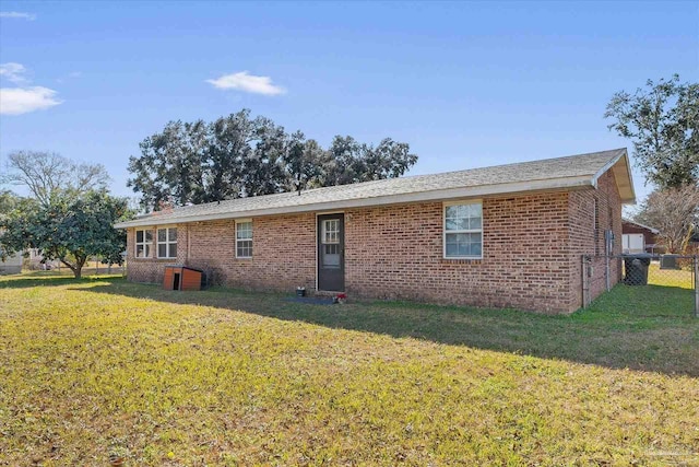 rear view of property featuring a yard