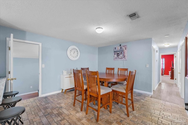 dining area with a textured ceiling