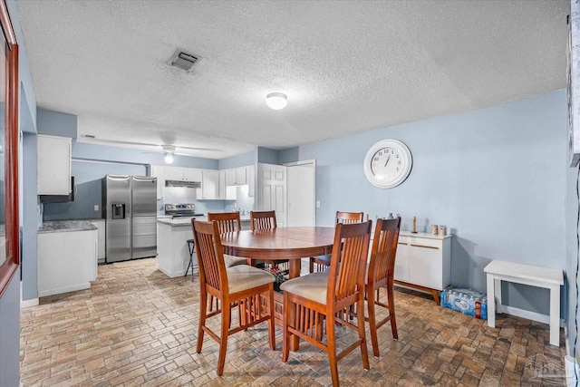 dining space with a textured ceiling