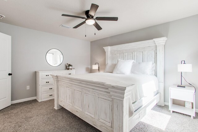 bedroom featuring visible vents, a ceiling fan, baseboards, and light colored carpet