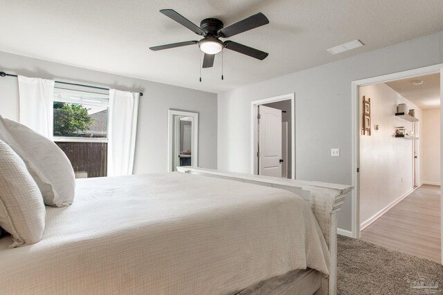 bedroom with baseboards, visible vents, a ceiling fan, and light colored carpet