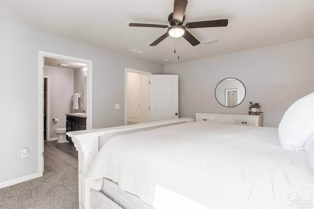 bedroom with a sink, baseboards, light carpet, and visible vents