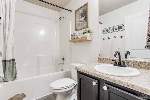 bathroom featuring vanity, wood finished floors, shower / bath combination with curtain, and toilet