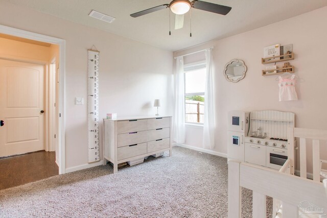 carpeted bedroom with baseboards, ceiling fan, and visible vents