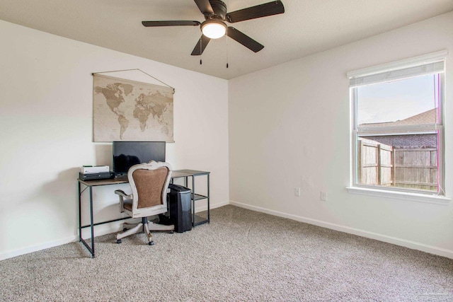 carpeted office with baseboards and ceiling fan