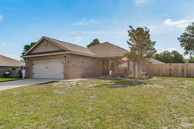 ranch-style home with an attached garage, a front lawn, fence, and driveway